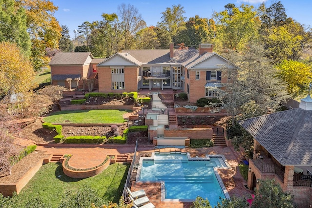 1442 Darbee Dr, Morristown, TN 37814 - back of house with stairs, a lawn, an outdoor pool, brick siding, and a chimney