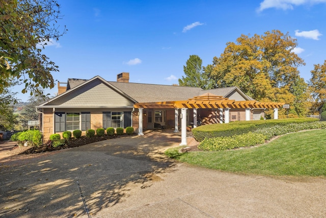 1442 Darbee Dr, Morristown, TN 37814 - view of front of property with a pergola, a chimney, concrete driveway, and brick siding