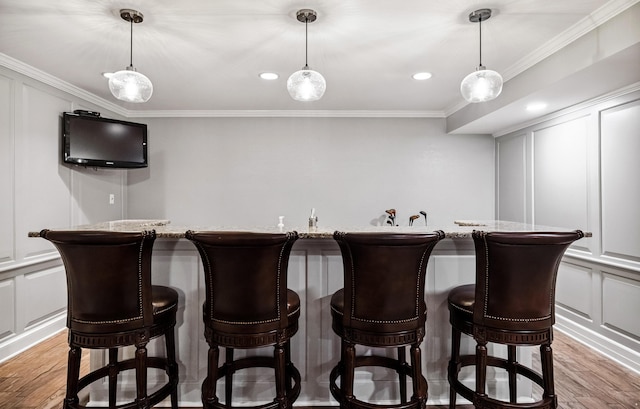 1442 Darbee Dr, Morristown, TN 37814 - indoor wet bar featuring a decorative wall, light wood finished floors, ornamental molding, pendant lighting, and recessed lighting