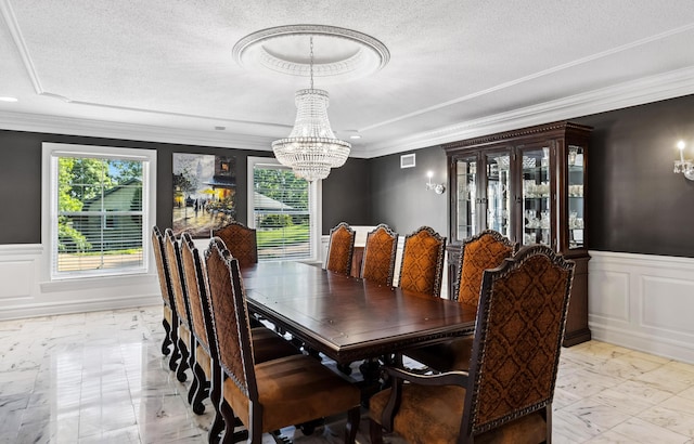 1442 Darbee Dr, Morristown, TN 37814 - dining area featuring a chandelier, light marble finish flooring, ornamental molding, wainscoting, and a decorative wall