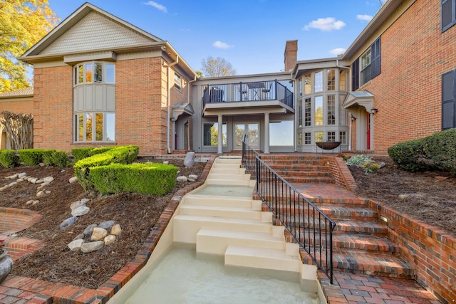 1442 Darbee Dr, Morristown, TN 37814 - view of front of property featuring stairway, a balcony, a chimney, and brick siding