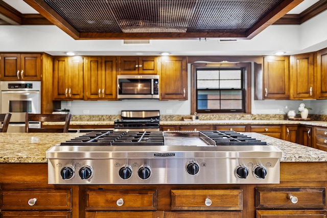 1442 Darbee Dr, Morristown, TN 37814 - kitchen featuring stainless steel appliances, ornamental molding, light stone counters, and brown cabinets