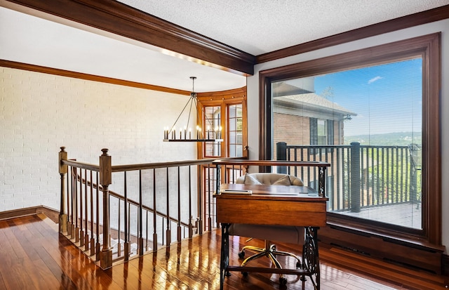 1442 Darbee Dr, Morristown, TN 37814 - living area featuring an upstairs landing, hardwood / wood-style flooring, a chandelier, ornamental molding, and brick wall