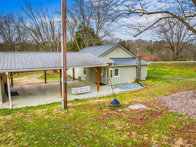 back of house featuring a yard and a patio area