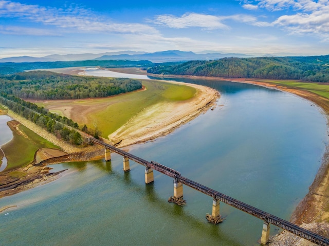 drone / aerial view featuring a water and mountain view