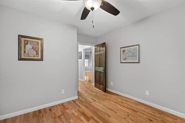 unfurnished room with ceiling fan and light wood-type flooring