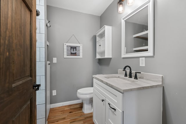 bathroom featuring vanity, hardwood / wood-style floors, and toilet