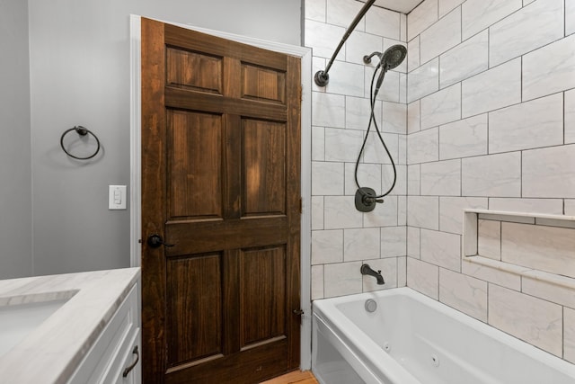 bathroom with vanity and tiled shower / bath combo