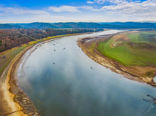 drone / aerial view featuring a water and mountain view