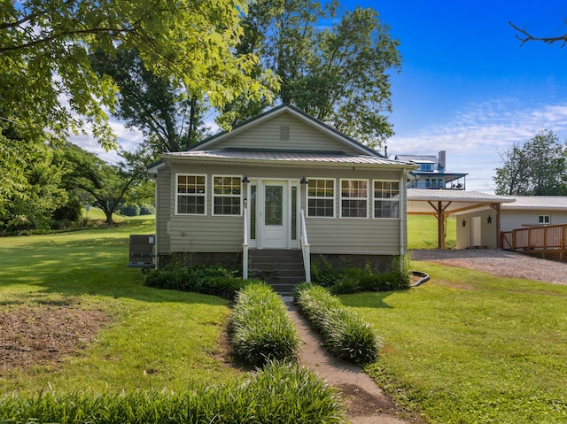 3569 Leadvale Rd, White Pine, TN 37890 - bungalow-style home featuring driveway, entry steps, a front lawn, metal roof, and a carport
