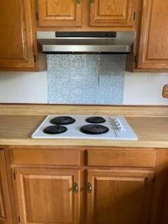 818 Cave Springs Rd, Tazewell, TN 37879 - kitchen with under cabinet range hood, white electric cooktop, light countertops, and brown cabinets