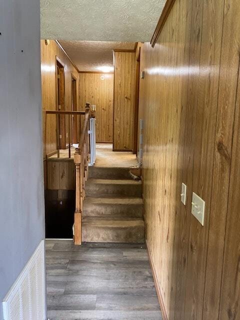 818 Cave Springs Rd, Tazewell, TN 37879 - stairway featuring wood finished floors, wooden walls, and a textured ceiling