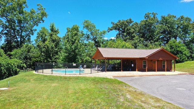 view of community with a lawn, a swimming pool, and a patio