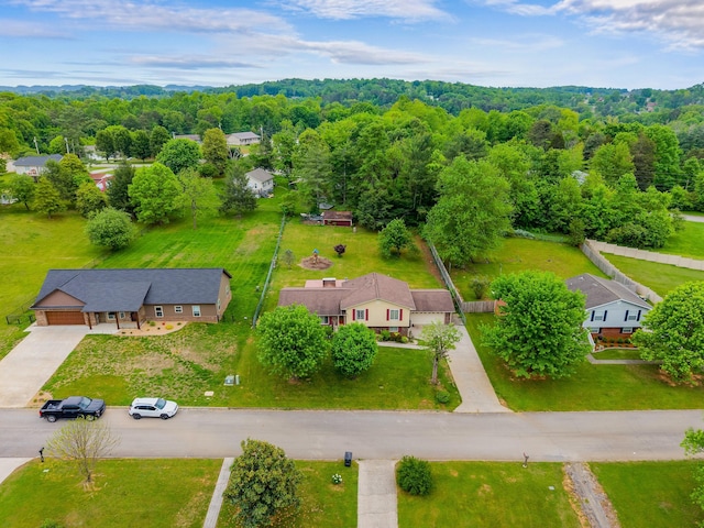 birds eye view of property with a forest view