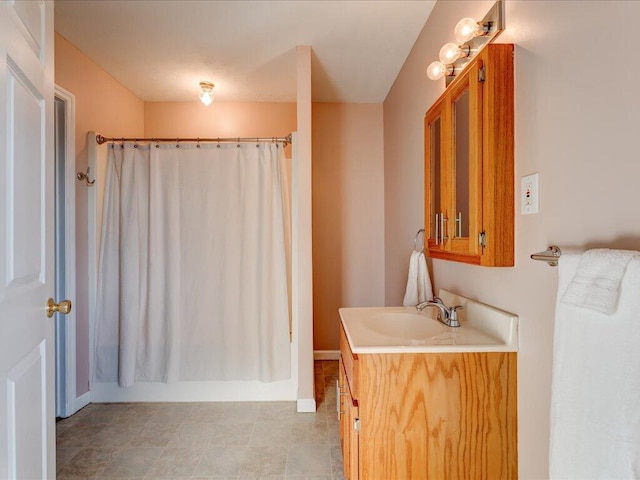 bathroom featuring vanity and shower / bathtub combination with curtain