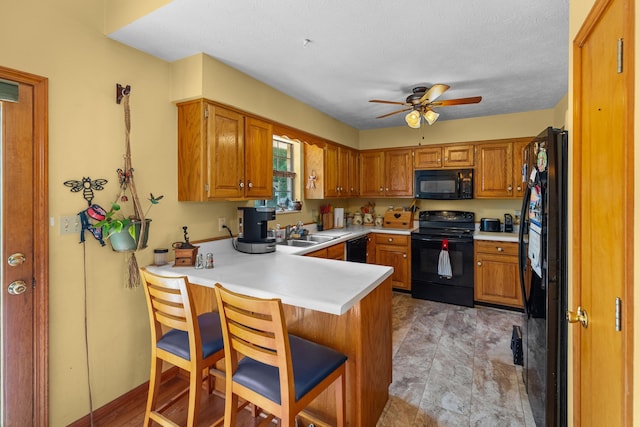 822 Osprey Dr, Morristown, TN 37814 - kitchen with black appliances, a peninsula, a ceiling fan, and light countertops