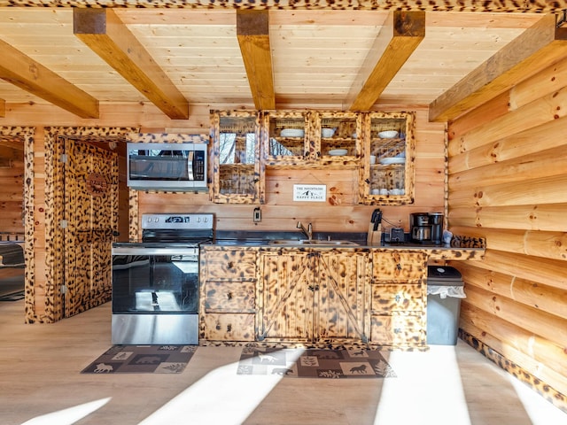 kitchen featuring sink, wooden walls, stainless steel appliances, and wooden ceiling