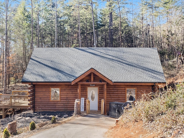 log home featuring a wooden deck