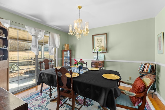 dining room with a notable chandelier and hardwood / wood-style flooring