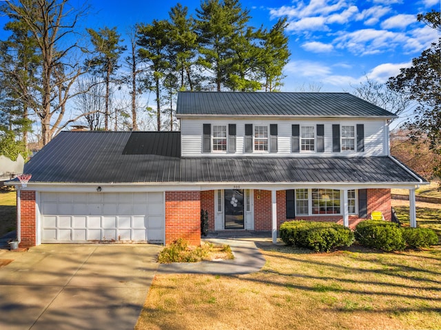 view of front of property with a garage and a front lawn