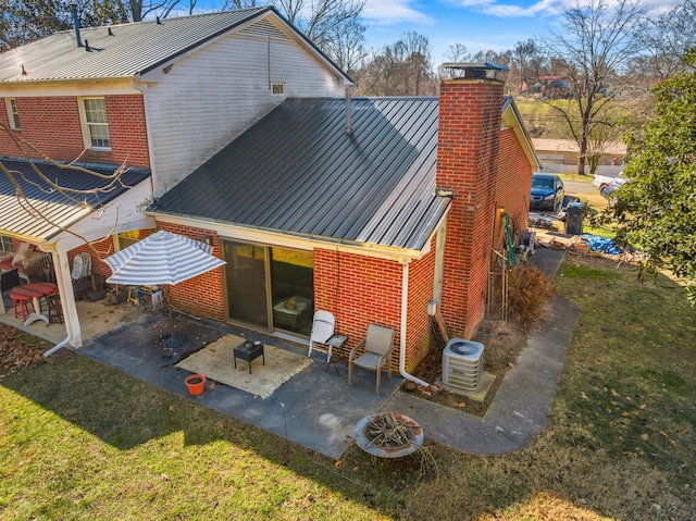 rear view of house featuring a patio area, central AC unit, and a lawn