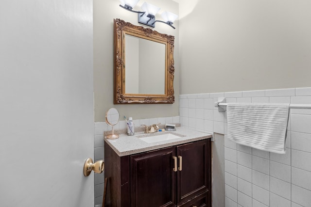 bathroom with tile walls and vanity