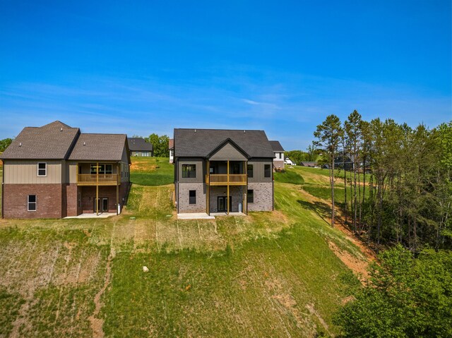 3183 Bridgewater Blvd, Morristown, TN 37814 - back of house with brick siding, a patio area, a lawn, and a balcony
