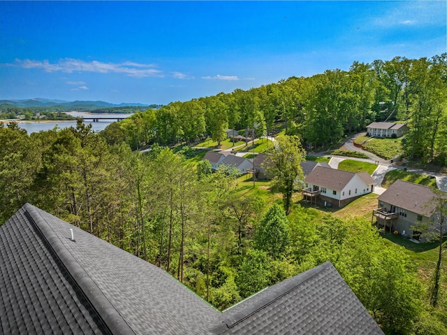aerial view with a water view and a forest view