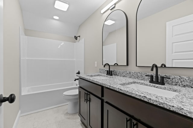 full bath with a sink, shower / bathing tub combination, marble finish floor, and toilet