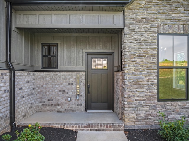 doorway to property featuring stone siding