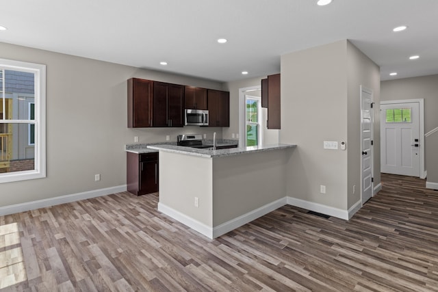 kitchen with recessed lighting, light wood-style flooring, baseboards, and stainless steel appliances