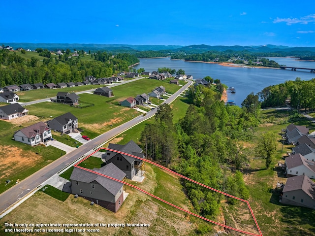 birds eye view of property featuring a water view and a residential view