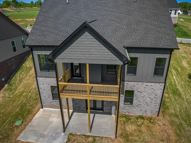 3183 Bridgewater Blvd, Morristown, TN 37814 - rear view of property with a lawn, board and batten siding, a patio area, and brick siding