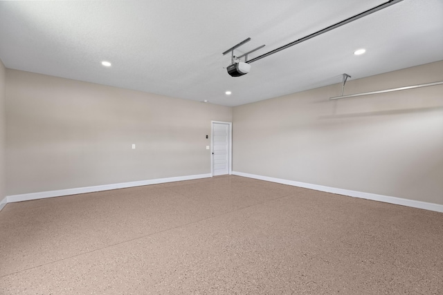 garage featuring recessed lighting, baseboards, and a garage door opener