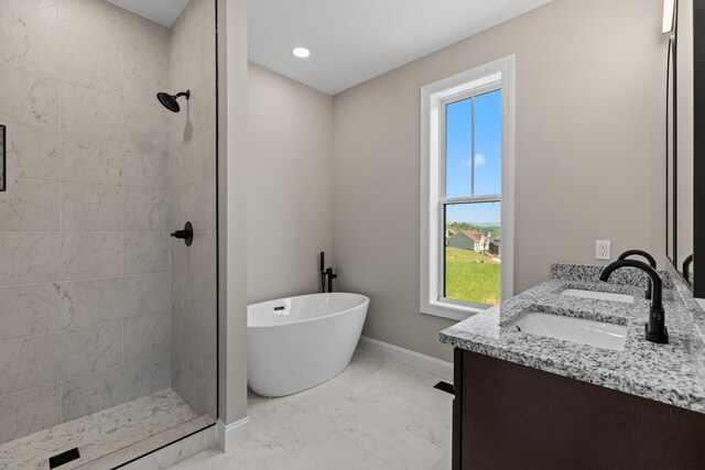 3183 Bridgewater Blvd, Morristown, TN 37814 - bathroom featuring marble finish floor, a freestanding tub, baseboards, tiled shower, and a sink