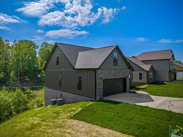 3183 Bridgewater Blvd, Morristown, TN 37814 - view of front of home featuring a garage, stone siding, a front yard, roof with shingles, and concrete driveway