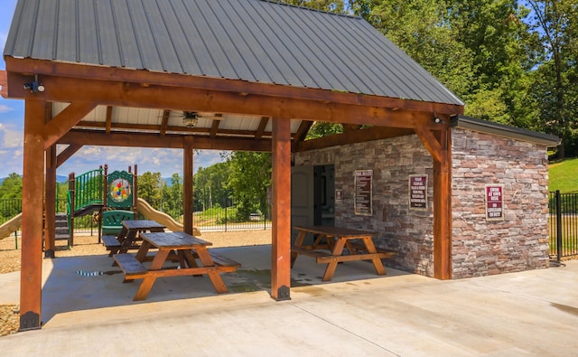exterior space featuring fence, a ceiling fan, a gazebo, and playground community