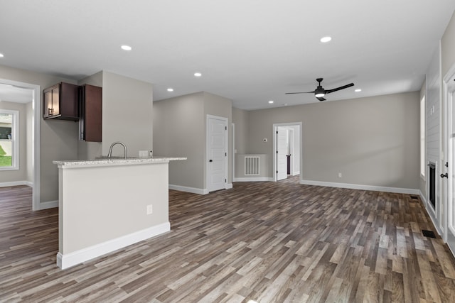 interior space with recessed lighting, baseboards, ceiling fan, and wood finished floors