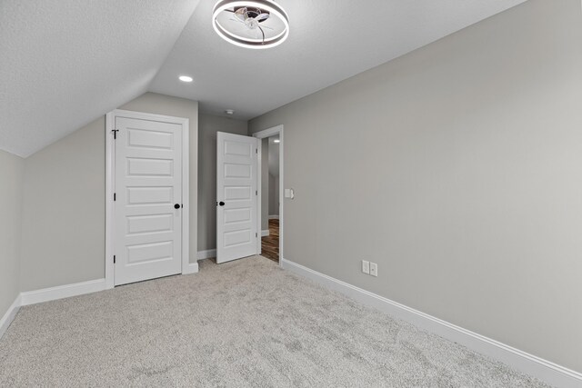 3183 Bridgewater Blvd, Morristown, TN 37814 - unfurnished bedroom featuring baseboards, carpet flooring, a textured ceiling, and lofted ceiling