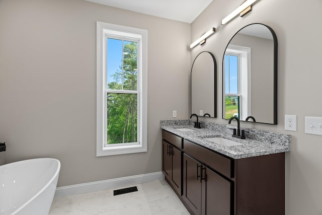 bathroom with visible vents, a sink, baseboards, and marble finish floor