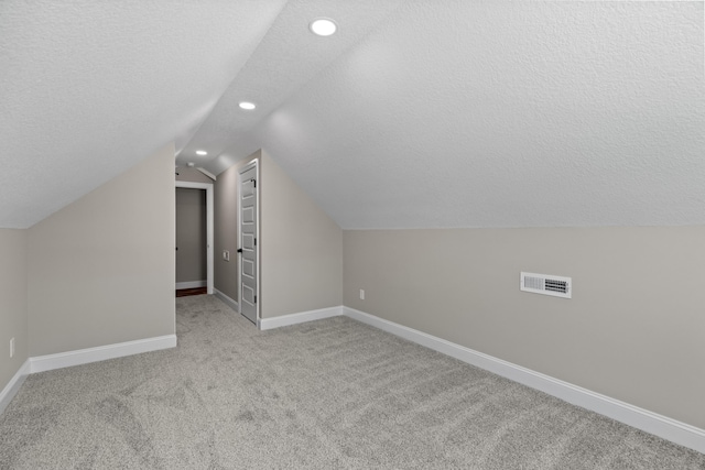 bonus room with carpet floors, visible vents, lofted ceiling, baseboards, and recessed lighting