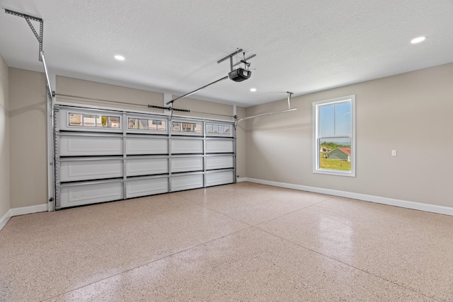 garage featuring baseboards, a garage door opener, and recessed lighting