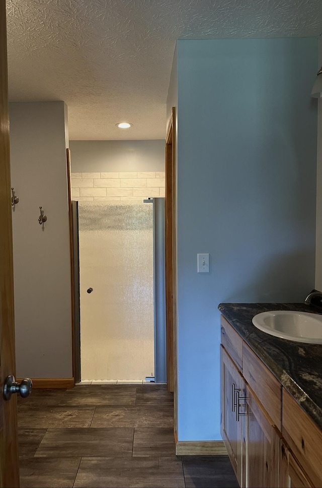 639 Mcguire Rd, New Market, TN 37820 - full bathroom featuring a stall shower, vanity, wood tiled floors, a textured ceiling, and recessed lighting