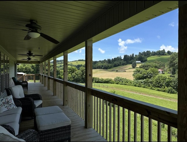 639 Mcguire Rd, New Market, TN 37820 - wooden deck featuring ceiling fan, a lawn, and view of scattered trees