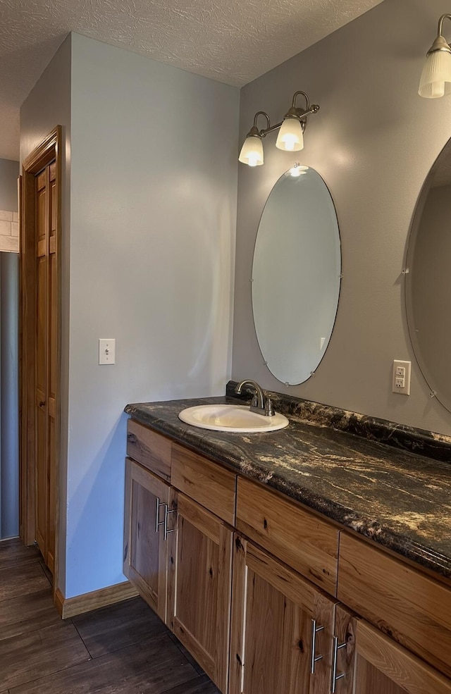639 Mcguire Rd, New Market, TN 37820 - bathroom with wood finished floors, vanity, and a textured ceiling