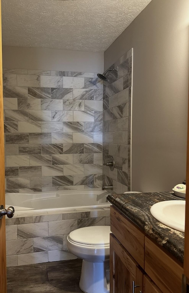 639 Mcguire Rd, New Market, TN 37820 - bathroom with vanity, tiled shower / bath, and a textured ceiling