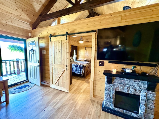 2119 Ted Moore Rd, Dandridge, TN 37725 - living room featuring wooden walls, a barn door, wooden ceiling, and wood finished floors