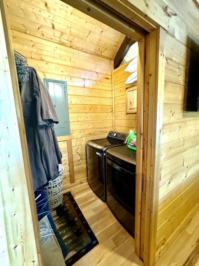 2119 Ted Moore Rd, Dandridge, TN 37725 - laundry room featuring washer and dryer, wooden walls, light wood-style floors, and electric panel