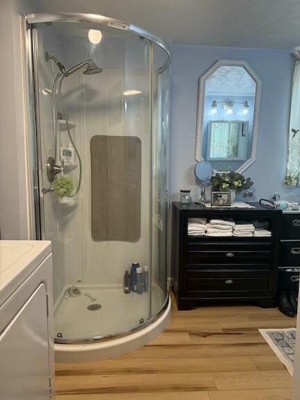136 Stonewall Way, Cosby, TN 37722 - full bath featuring washer / dryer, vanity, a stall shower, and wood finished floors