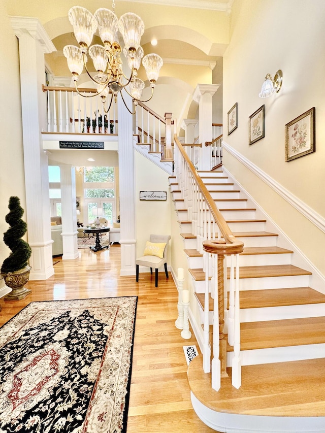 1564 Tranquility Trl, Dandridge, TN 37725 - stairway featuring a towering ceiling, wood finished floors, arched walkways, and crown molding